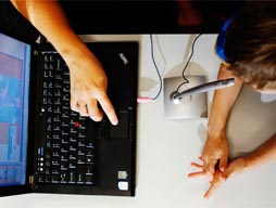 Hand tapping on laptop keyboard
