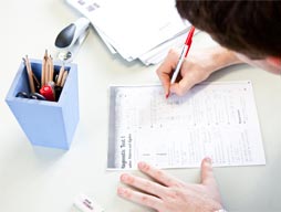 person filling in paper form
